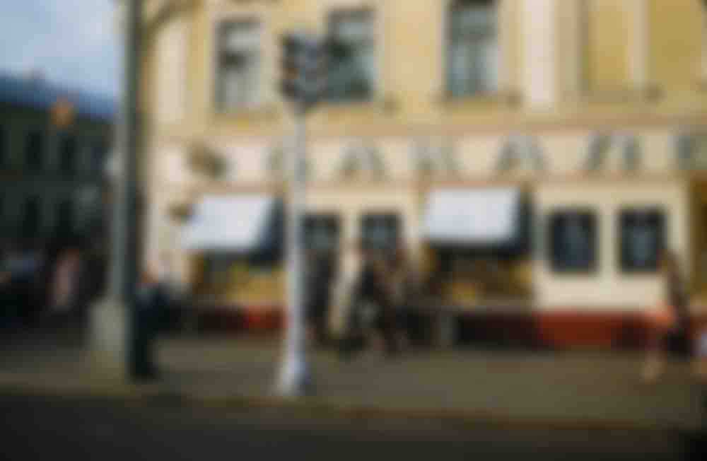 A traffic light and a grocery store at an unknown location.