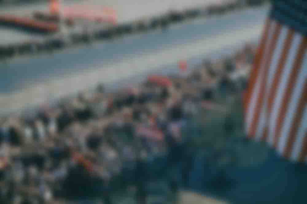 Parade-goers bearing portraits of Stalin and Lenin gather on Manezhnaya ploshchad, Moscow.