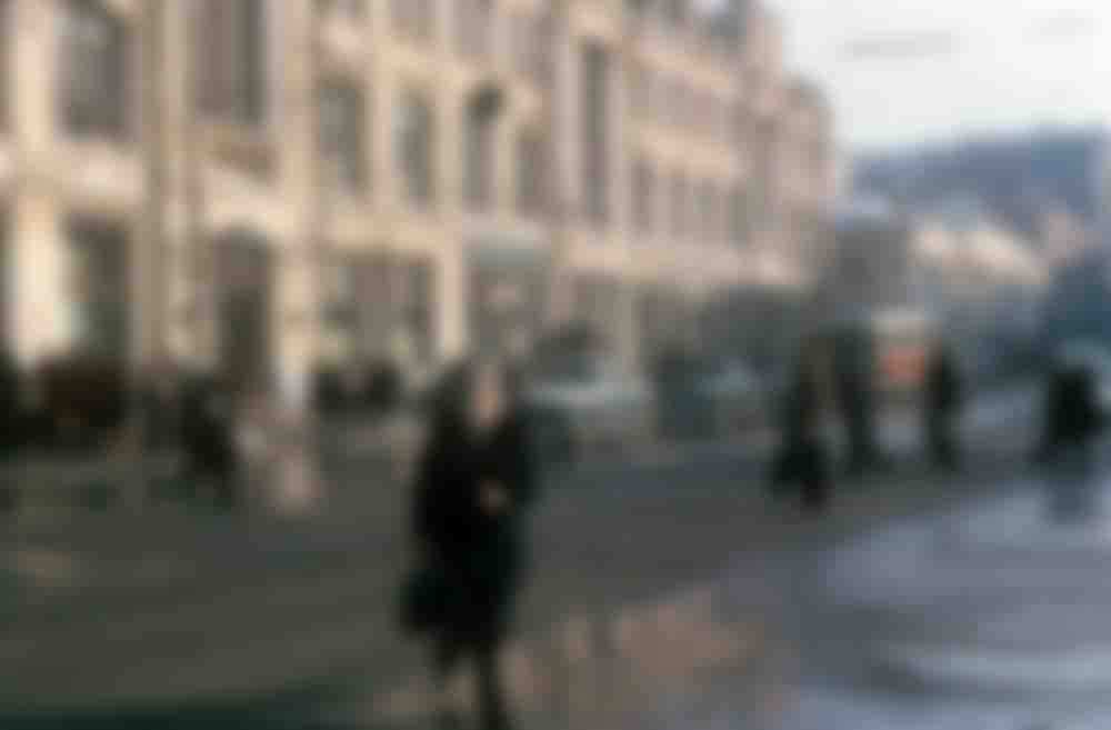 Pedestrians crossing a slushy street in central Moscow.