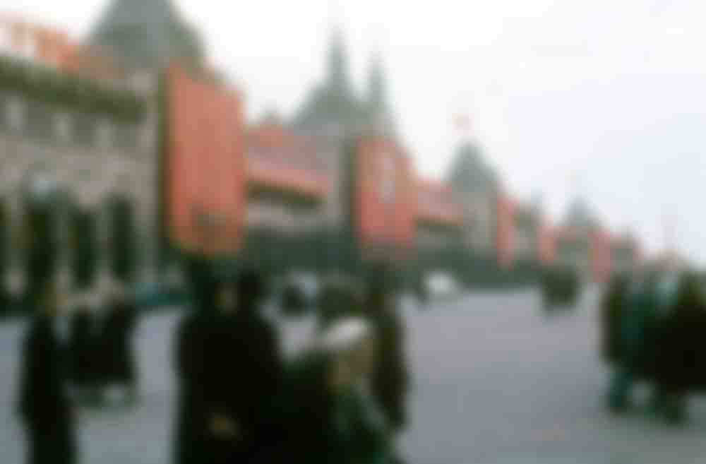 Strolling on Red Square. The GUM department store is decorated for May 1, International Workers' Day, one of the most important holidays in the Soviet Union. 